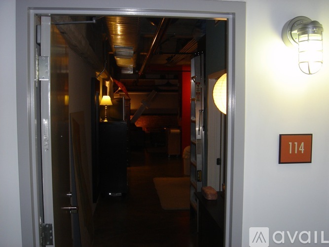 A hallway with a sign that says 114 on the wall.