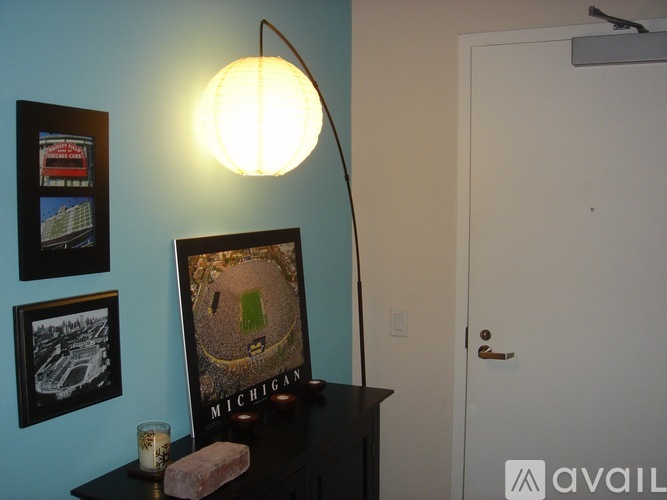 A lamp with a globe shaped shade is on a desk.