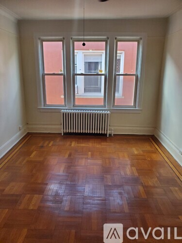 A room with wooden floors and a window.