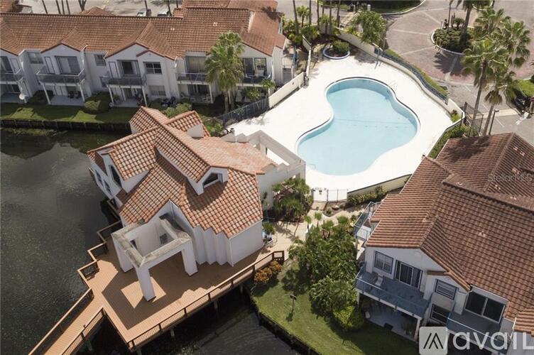 A swimming pool is surrounded by houses.