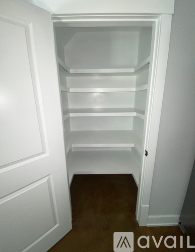 Empty white shelves in a white closet.