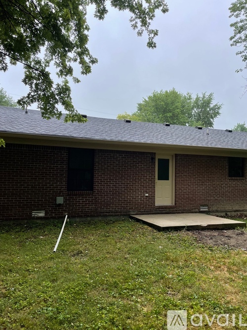 A house with a brown brick exterior and a grey roof.