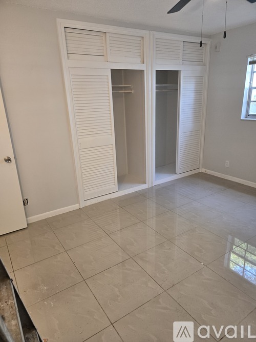 A room with a tiled floor and a ceiling fan.