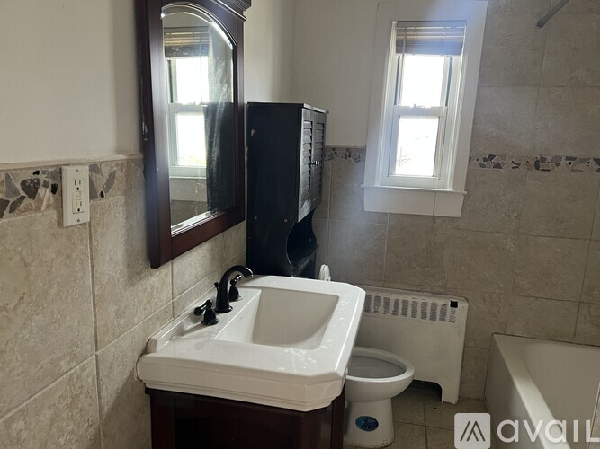 A bathroom with a sink, toilet, and bathtub.