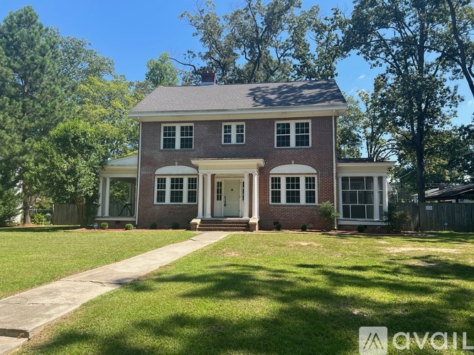 A house with a front yard and a driveway.