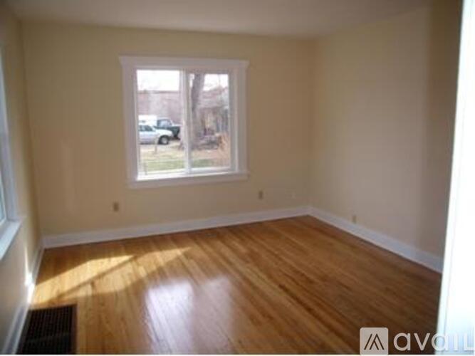 A room with wooden floors and a window.