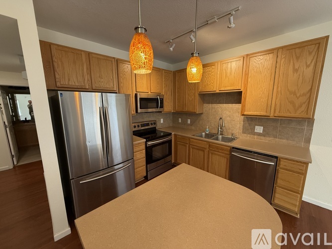 A kitchen with wooden cabinets and a refrigerator.