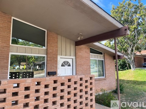 A house with a white door and windows is for sale.