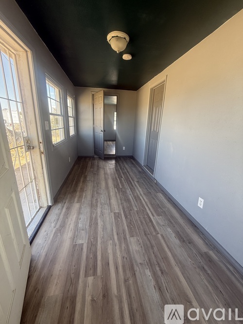 A room with wooden floors and white walls.
