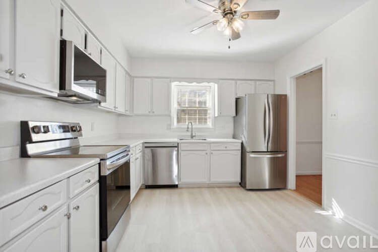 A kitchen with white cabinets and stainless steel appliances.