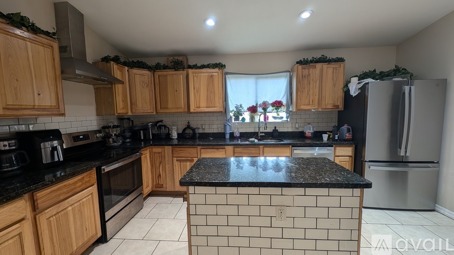 A kitchen with wooden cabinets and a black countertop.