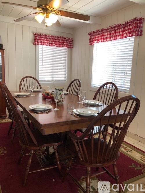 A dining room with a table set for four.