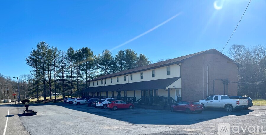 A parking lot with cars and a building in the background.