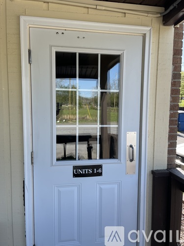 A white door with a glass window and a silver handle.