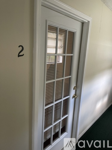 A white door with a number 2 on the wall.