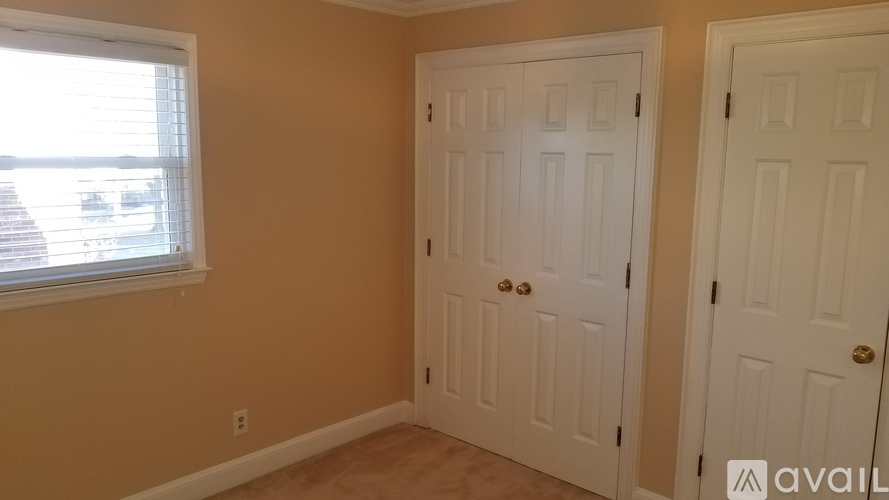 A room with two doors and a window.