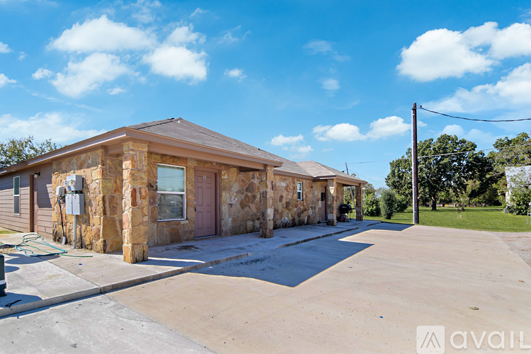A house with a stone exterior is available for sale.