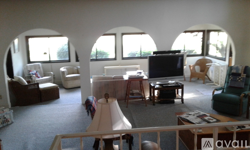 A living room with a white couch and a television.