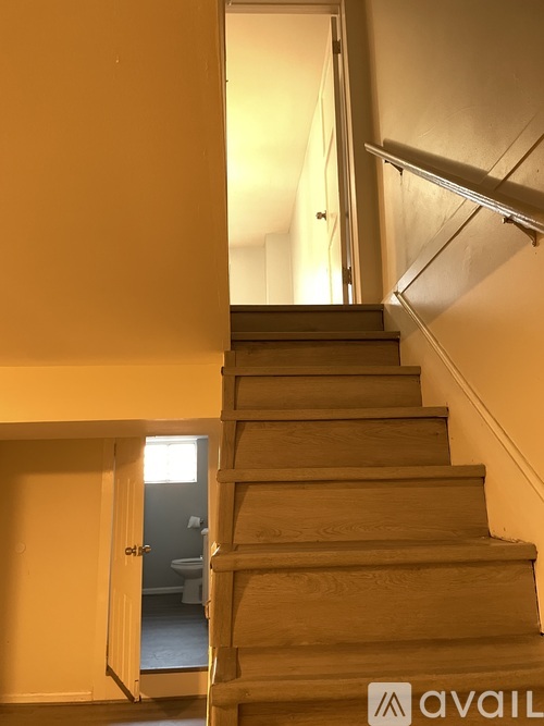 A staircase with a light on the side.