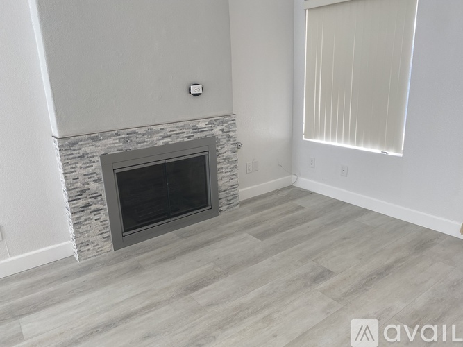 A modern living room with a fireplace and wooden flooring.