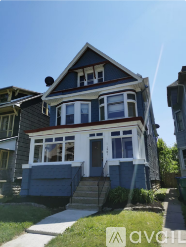 A two-story house with a blue exterior and white trim.