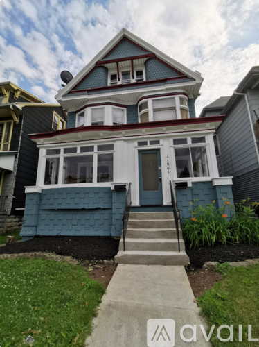 A blue house with a white door and windows.