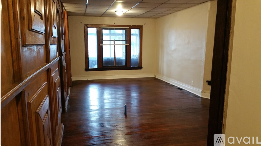 A room with wooden floors and a window.