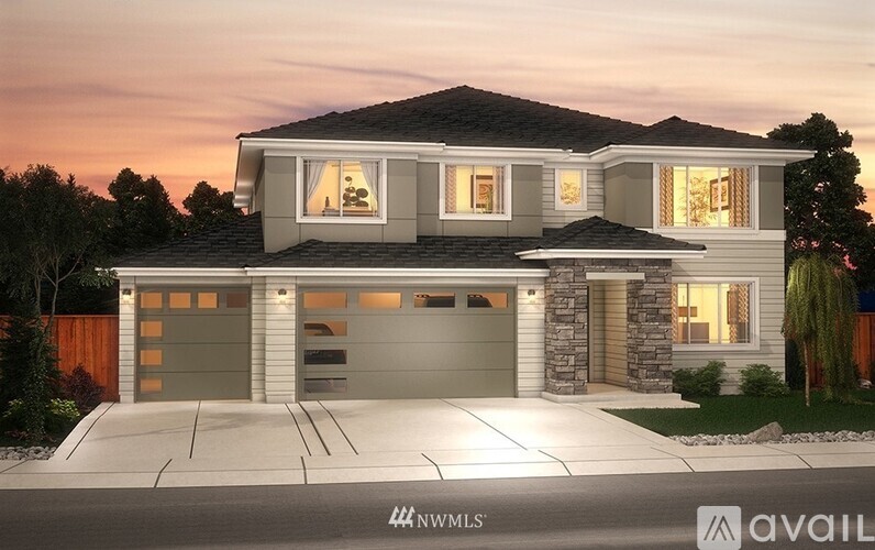 A modern house with a stone pillar in front of it.