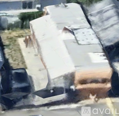 A white car is parked on the side of the road.