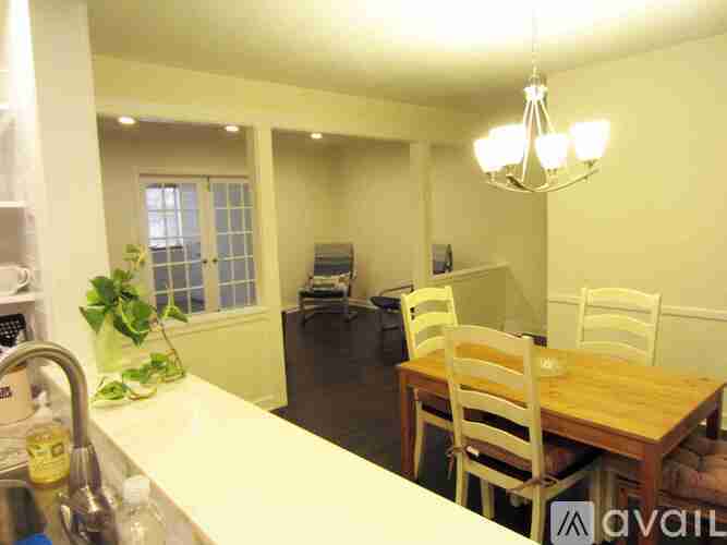 A kitchen with a table and chairs.
