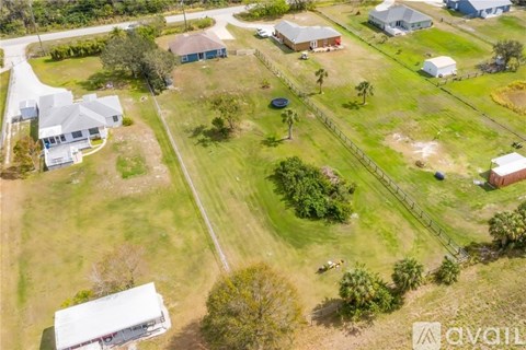 A bird's eye view of a residential area with houses and green lawns.