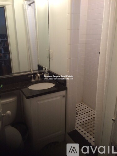 A bathroom with a sink, mirror, and toilet.