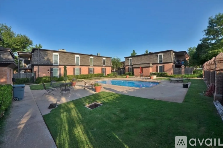 A sunny day at a residential area with a swimming pool and apartment buildings.