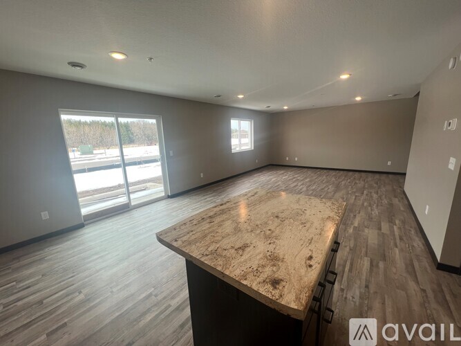 A spacious room with a large island in the middle.