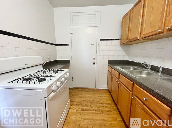 A kitchen with a white stove and wooden cabinets.