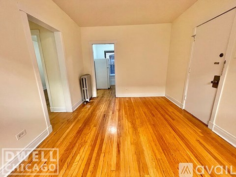 A room with wooden floors and white walls.