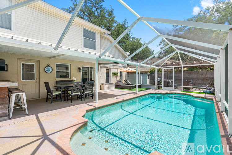 A pool in a backyard with a glass ceiling.