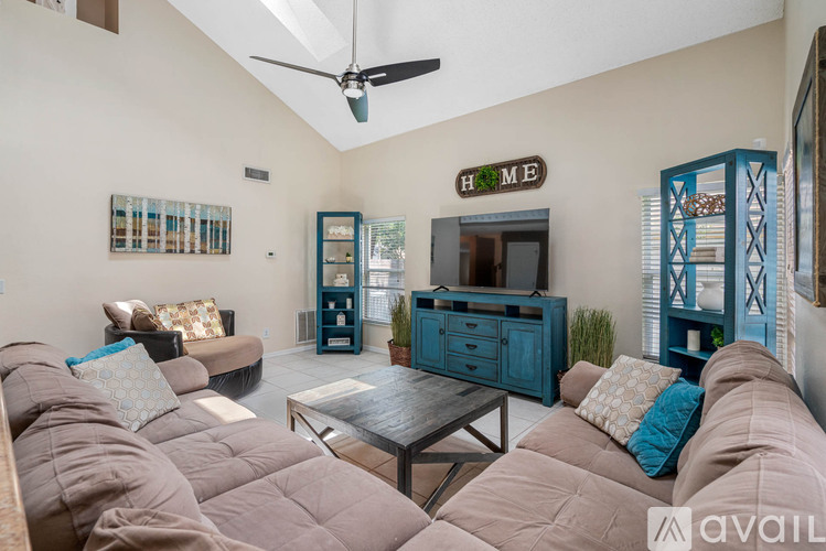 A living room with a brown couch and a blue cabinet.