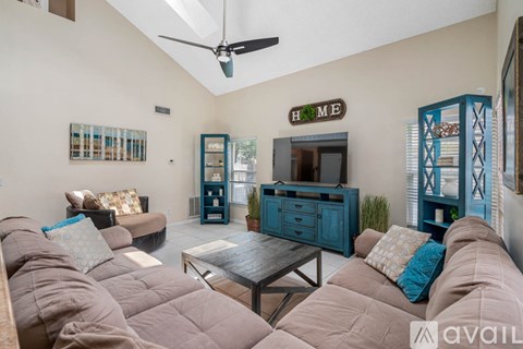 A living room with a brown couch and a blue cabinet.