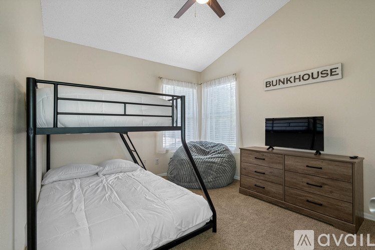 A bedroom with a bunk bed and a television.