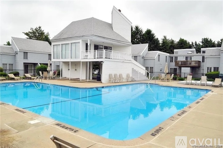 A large house with a pool in front of it.