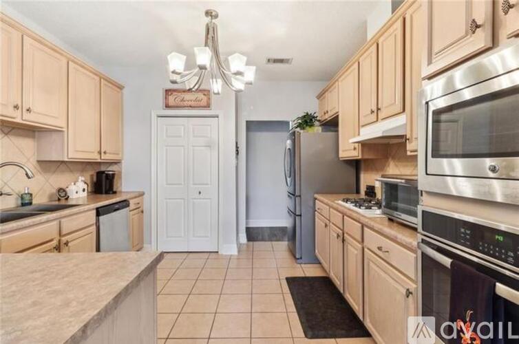 A kitchen with wooden cabinets and stainless steel appliances.
