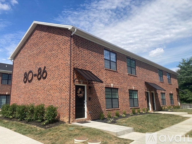 A red brick house with the number 80-88 on the front.