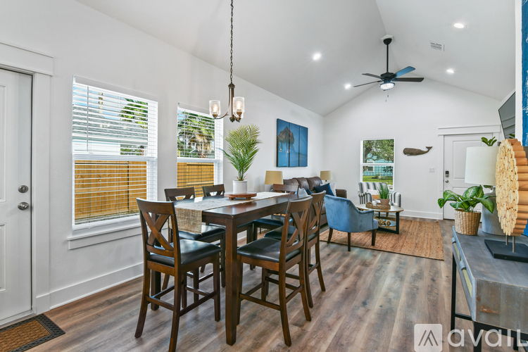A dining room with a wooden table and chairs.