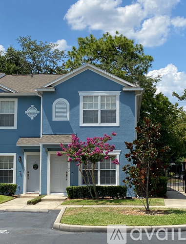 A blue house with a white door and windows.