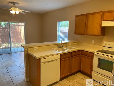 A kitchen with a white dishwasher and a white stove top oven.