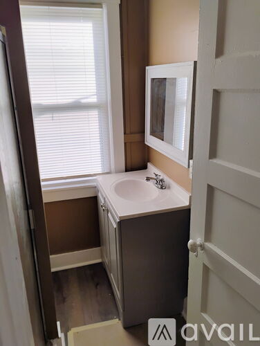 A bathroom with a sink and a mirror.