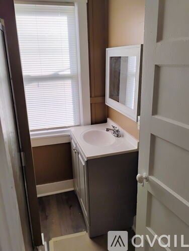 A bathroom with a sink and a mirror.