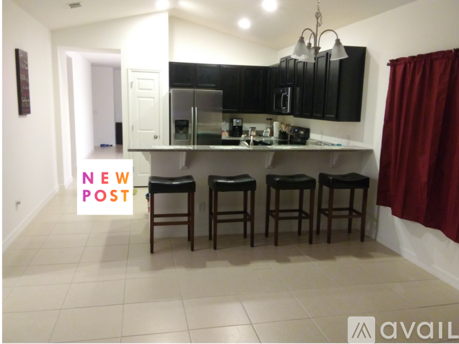A kitchen with a bar stool and a sign that says "NEW POST".