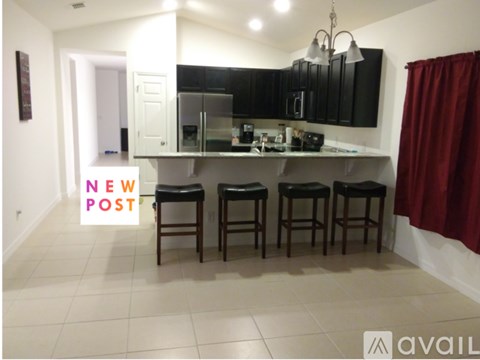 A kitchen with a bar stool and a sign that says "NEW POST".